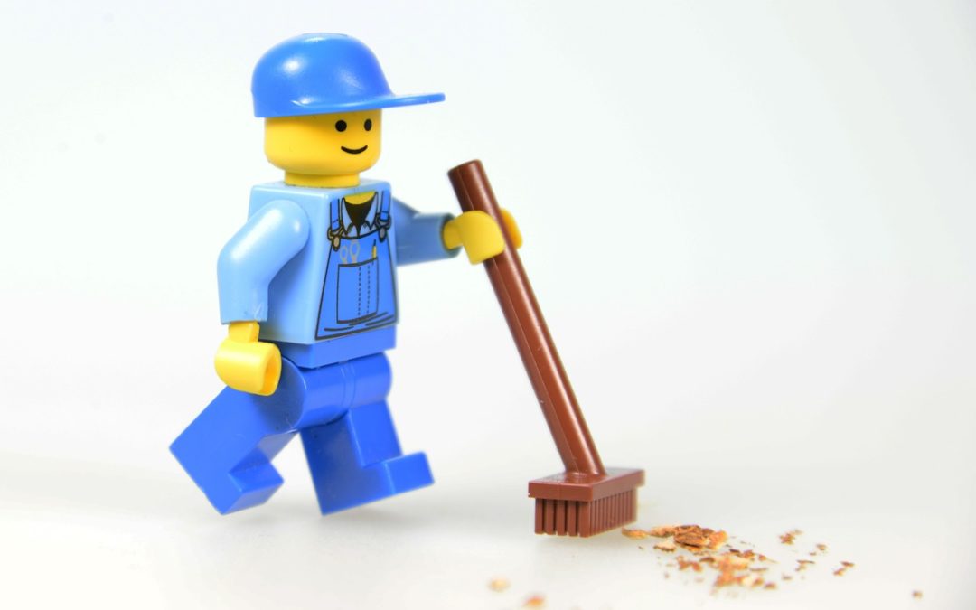 lego man sweeping dirt