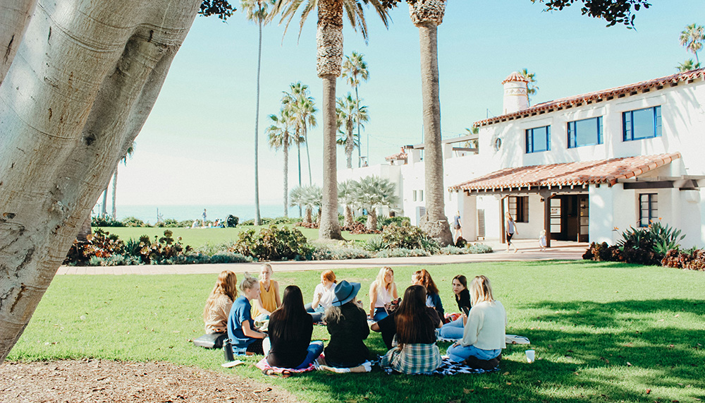 College students sitting in a circle outside